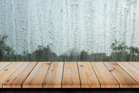 Wood table with rain water drop on glass background.の写真素材