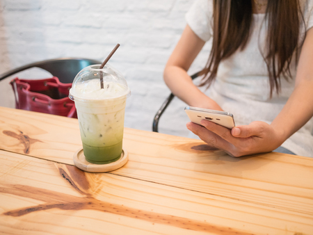 Closeup ice green tea  on wood table in the cafe.の写真素材