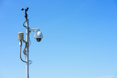 Security CCTV camera on blue sky background.の写真素材