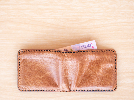 Top view of brown wallet on wood table background.の写真素材