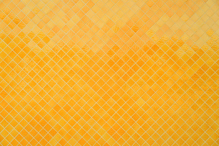 Background texture of yellow mosaic on the wall.の写真素材
