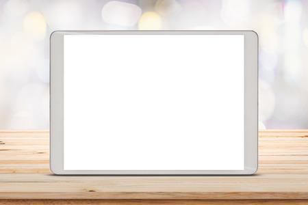 Digital tablet on wood table with blur shopping mall background.の写真素材