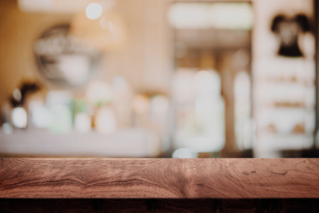 Empty top of wodd table with blur cafe or coffee shop background.