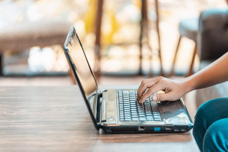 Close up man's hand using laptop in home.