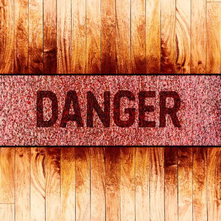 Danger warning sign text on rusty metal texture background.の写真素材