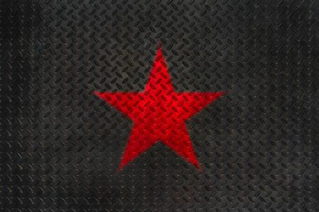 Red star on grunge metal diamond plate floor texture and background.の写真素材