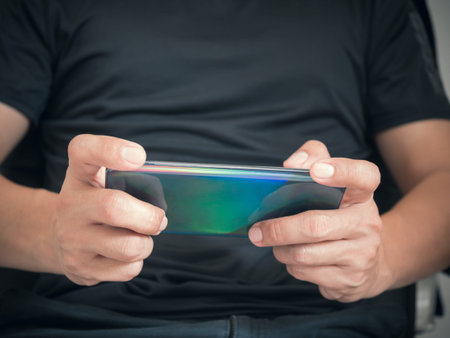 Man playing game on smartphone.