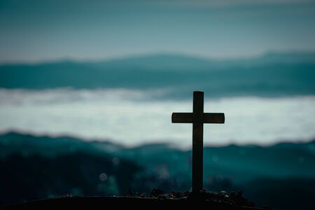 Silhouette of cross on mountain natural background.の写真素材