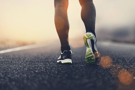 close up sport shoes of a runner on road for fitness healthy lifestyle.の写真素材