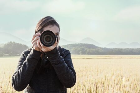 Traveler young taking photograph with rice fields background.の写真素材