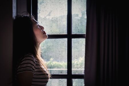 Asian woman quarantine herself at home. After the Coronavirus or Covid-19.の写真素材