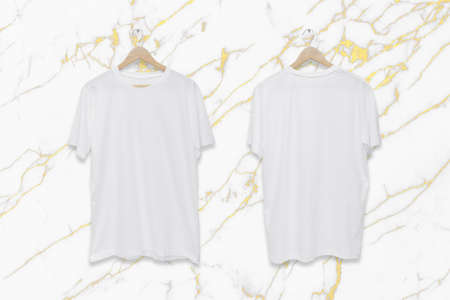 White blank front and back t-shirt on white marble wall background.の写真素材