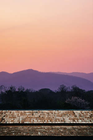 Roof of old wooden houses with the atmosphere before sunrise on the mountain background.の写真素材