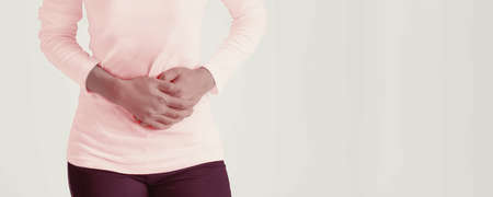 African american woman feel having painful stomachaches during menstruation.の写真素材