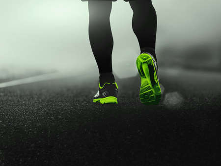 close-up sport shoes of a runner on road for fitness healthy lifestyle.の写真素材