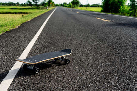 Surf skate on road in the countryside.の写真素材