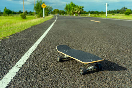 Surf skate on road in the countryside.の写真素材