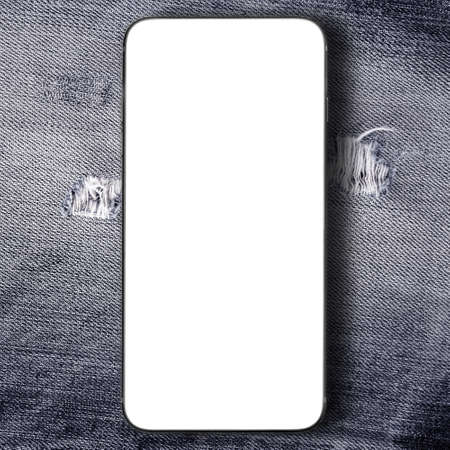 Smartphone on black denim jeans texture background.の写真素材