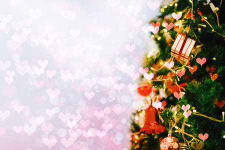 Close-up gift box on Christmas tree with abstract bokeh light background.の写真素材
