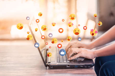 Woman using laptop with social media, Chatting with friends online, Concept of work form home and living on vacation and playing social media.の写真素材