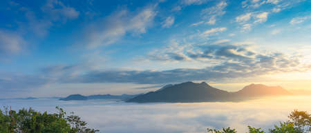 Beautiful foggy winter sunrise on the mountains in the northeast of Thailand.の写真素材