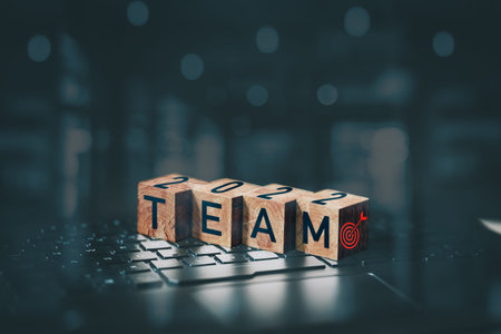 Team word on wooden cube block which is placed on a laptop. Business growth and goal in 2022...