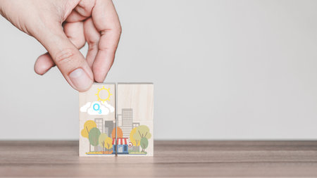 Hand holding with O3 chemical formula icon on wooden cube block with abstract cartoon city. Green...
