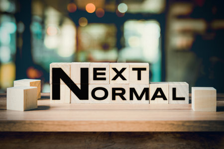 Next Normal word on wooden cube block on wood table background.の写真素材