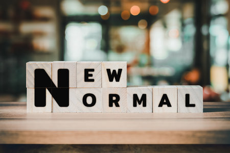 New Normal word on wooden cube block on wood table background.