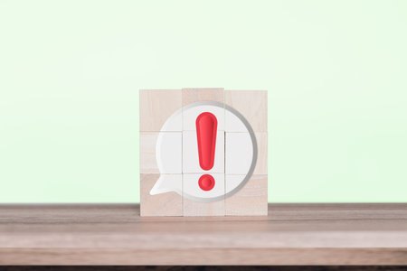 Red alert warning icon with chat message on wooden cube with social button icons concept design and...