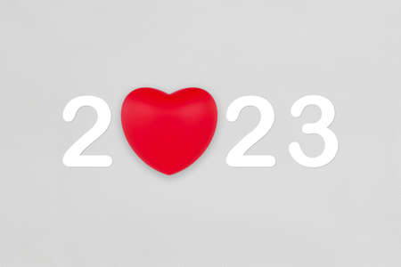 2023 with red heart symbol on white fabric texture background for Happy New Year.の写真素材