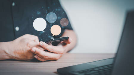 Man hand using smartphone typing live chat chatting on application communication digital web and social network concept. Social media application chat box.の写真素材