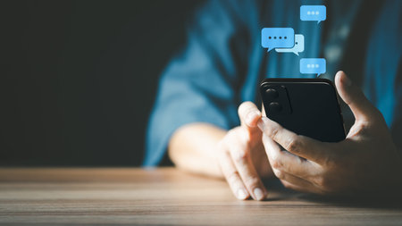 Man hand using smartphone typing live chat chatting on application communication digital web and social network concept. Social media application chat box.の写真素材