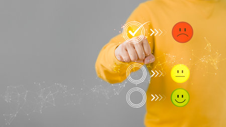 Man touching the virtual screen on the unhappy angry face icon in give rating to service experience on application. Online customer review satisfaction feedback survey.の写真素材