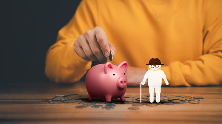 Man putting coin into piggy bank for saving money, retirement, health care, business finance and investment.の写真素材
