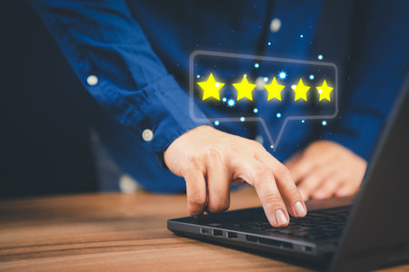 Man using laptop computer to rate service experience in application online. Customer reviews opinion poll satisfaction survey and testimonial.の写真素材