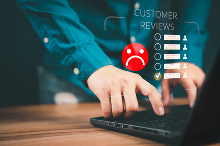 Unhappy man customer with sad emotion face on laptop. Bad review and service dislike poor quality, low rating, bad social media not good. Customer experience dissatisfied and testimonial concept.の写真素材