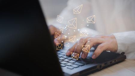 Email Marketing and Newsletters, Technology and lifestyle concepts. Man's hand using computer laptop and sending online message with email icon.の写真素材