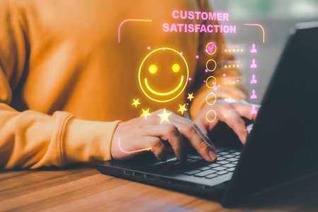 Man hand using computer laptop with popup five star icon for feedback review satisfaction service, testimonial. Customer service experience and business satisfaction survey.の写真素材