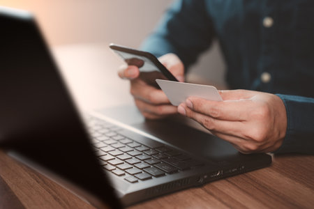 Man using credit card for purchasing and shopping online on mobile phone. Mobile payment with wallet app technology. Digital money transfer, banking and e commerce concept.の写真素材
