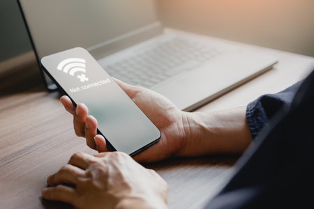 Man using a mobile phone to connect to wifi but wifi not connected, and waiting to loading digital business data form website, concept technology of waiting for connect to wifi by smartphone.の写真素材