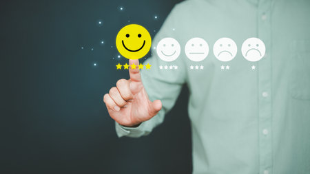 Man touching the virtual screen on the happy smiley face icon to give satisfaction in service. Rating very impressed. Customer service, testimonial and satisfaction concept.の写真素材