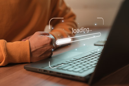 Man using laptop for download software and waiting to loading digital business data form website, concept of waiting for load of loading bar.の写真素材