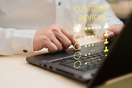 Man hand using computer laptop with popup five star icon for feedback review satisfaction service, testimonial. Customer service experience and business satisfaction survey.の写真素材
