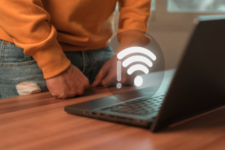 Man using a computer laptop to connect to wifi but wifi not connected, and waiting to loading digital business data form website, concept technology of waiting for connect to wifi.の写真素材