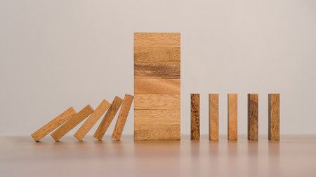 Business Risks and Strategies. Stopping Wood Block Domino. Business Crisis Impact or hedging concept, Prevention and development towards security.の写真素材