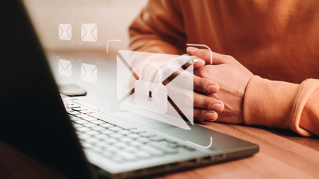 Freelancer's hand using computer laptop and sending online message with email icon, email marketing concept, send email or newsletter, internet network working online.の写真素材