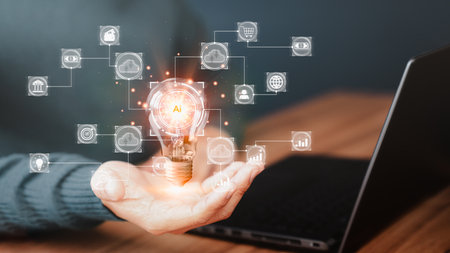 Man holding a light bulb while working on a laptop to think and create new ideas. Ai technology, cloud computing, technology bigdata and business process strategy and smart industry.の写真素材