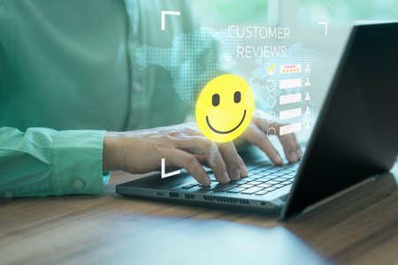 Man hand using computer laptop with popup five star icon for feedback review satisfaction service, testimonial. Customer service experience and business satisfaction survey.の写真素材