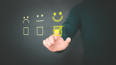 Man touching the virtual screen on the happy smiley face icon to give satisfaction in service. Rating very impressed. Customer service, testimonial and satisfaction concept.の写真素材